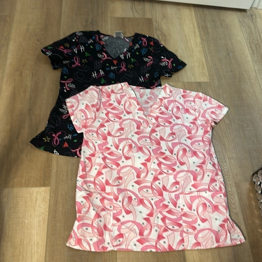Two women’s pink ribbon scrub tops size medium